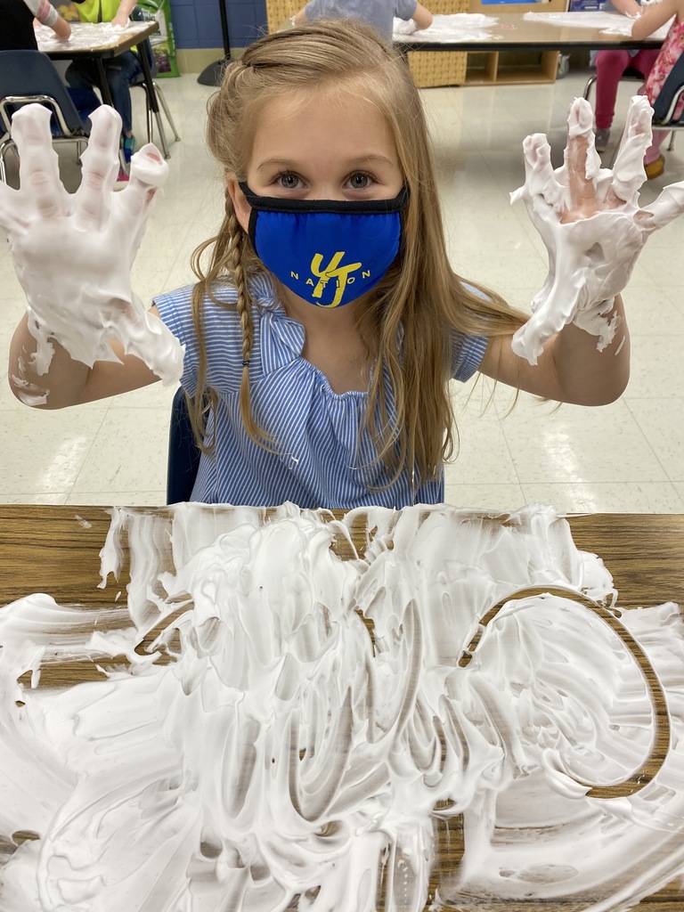 Image of student writing letters with shaving cream
